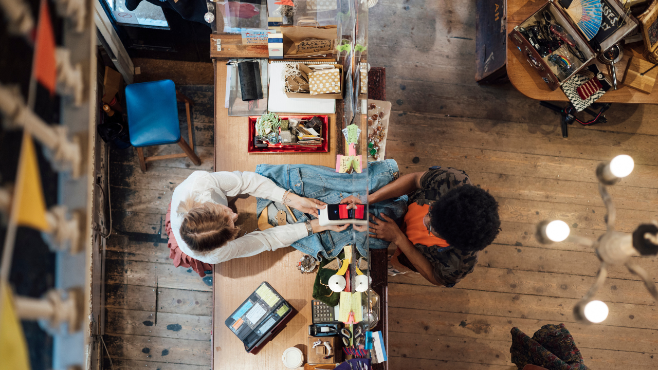 Women sitting across from one another doing a project together
